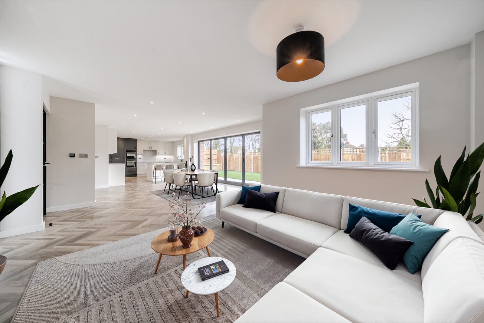 The same open-plan living space virtually staged with furniture