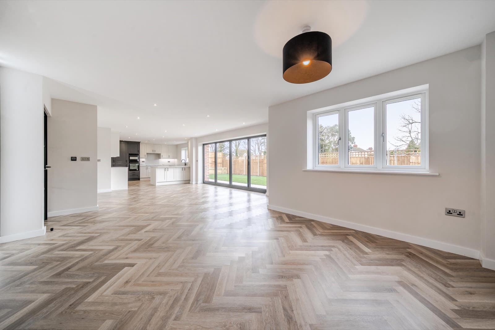 Empty open-plan living space before virtual staging